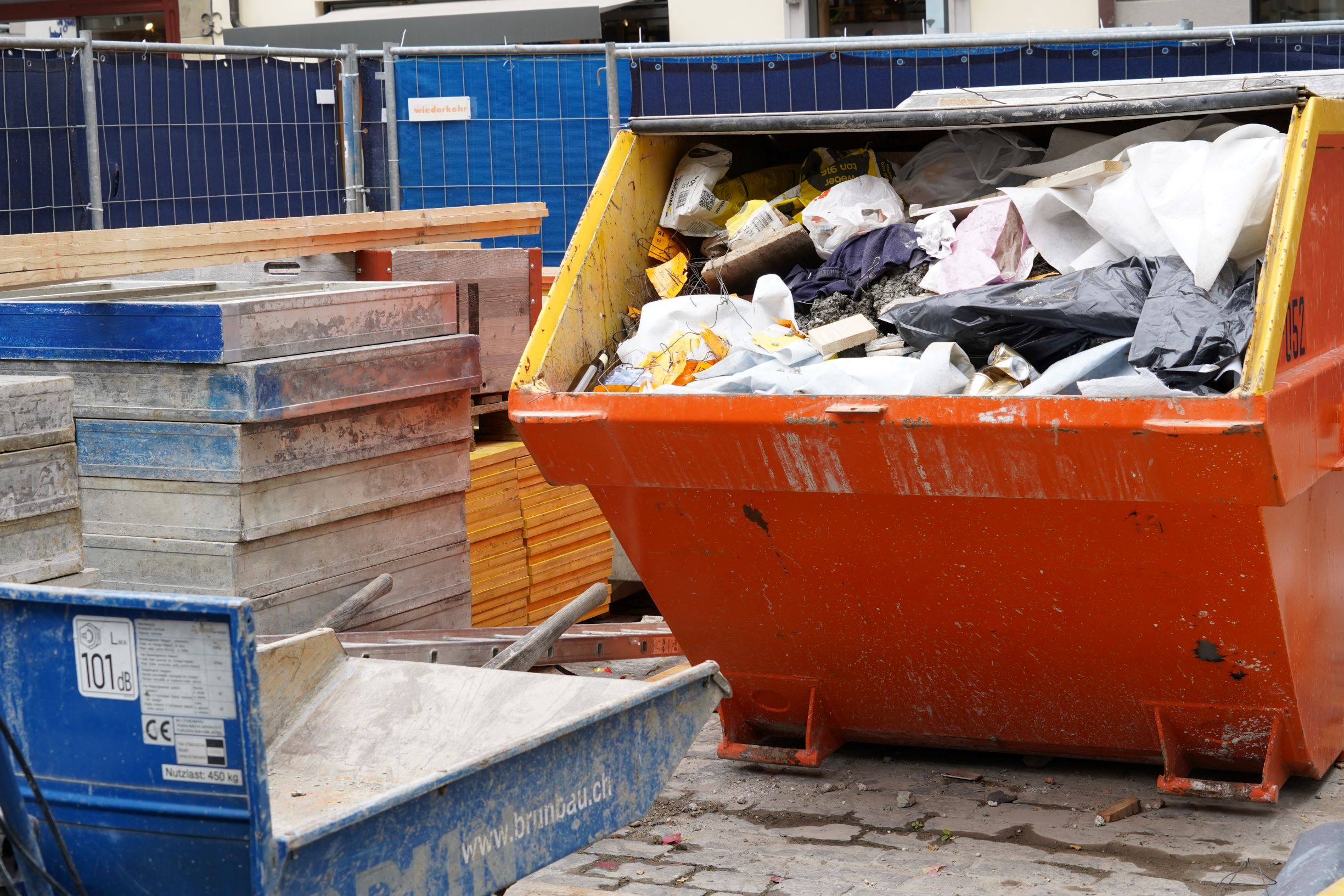 Plastic waste in construction. Skip on a construction site filled to the brim
