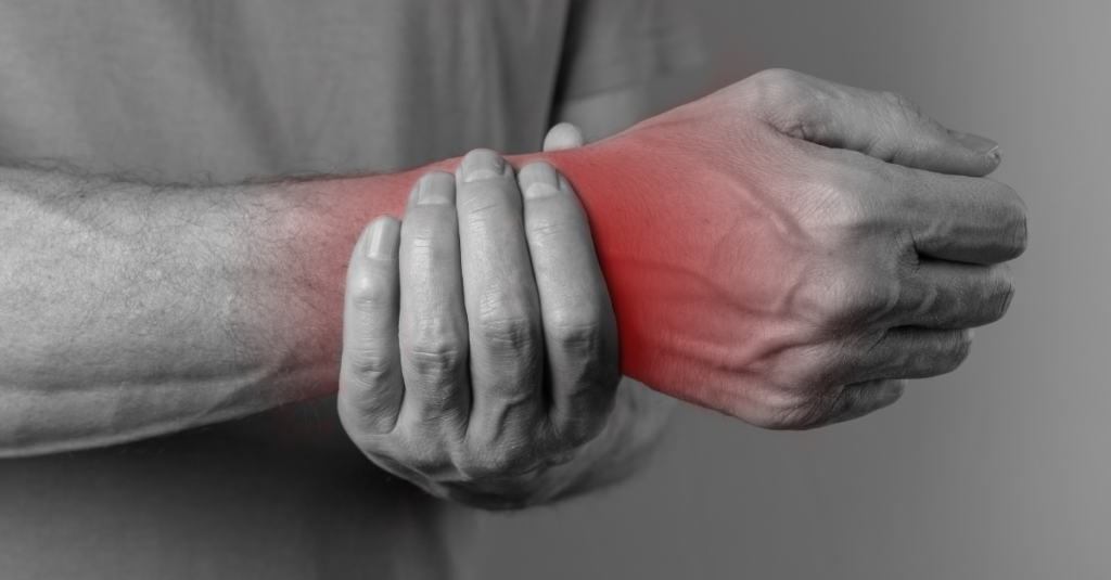 Hand holding an in pain arm