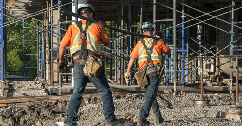 Stress Awareness - Construction workers lifting heavy material